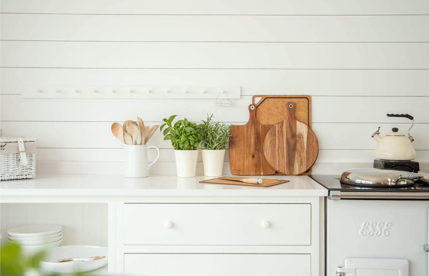 Potted herbs on a white kitchen counter
