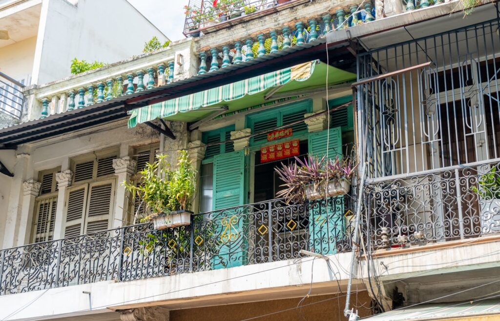 Apartment balcony railing with rectangular planters and green plants